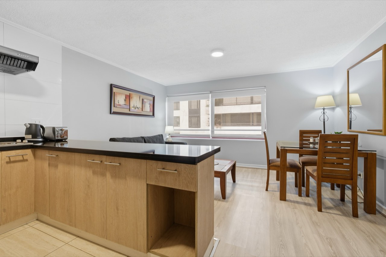 Living comedor integrado con cocina americana - Suite 106 Suites Vitacura