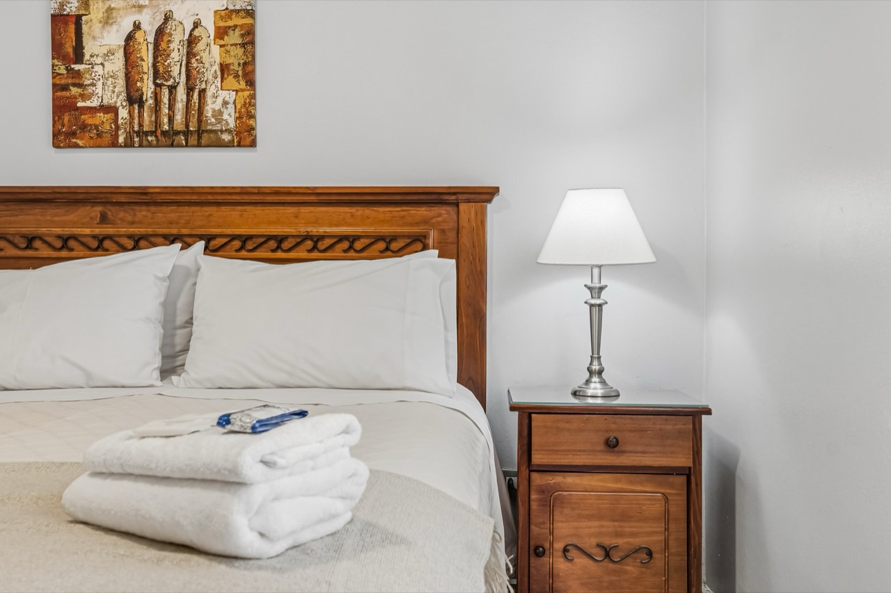 Detalle de cabecera de madera con velador - Suite 405 Suites Vitacura