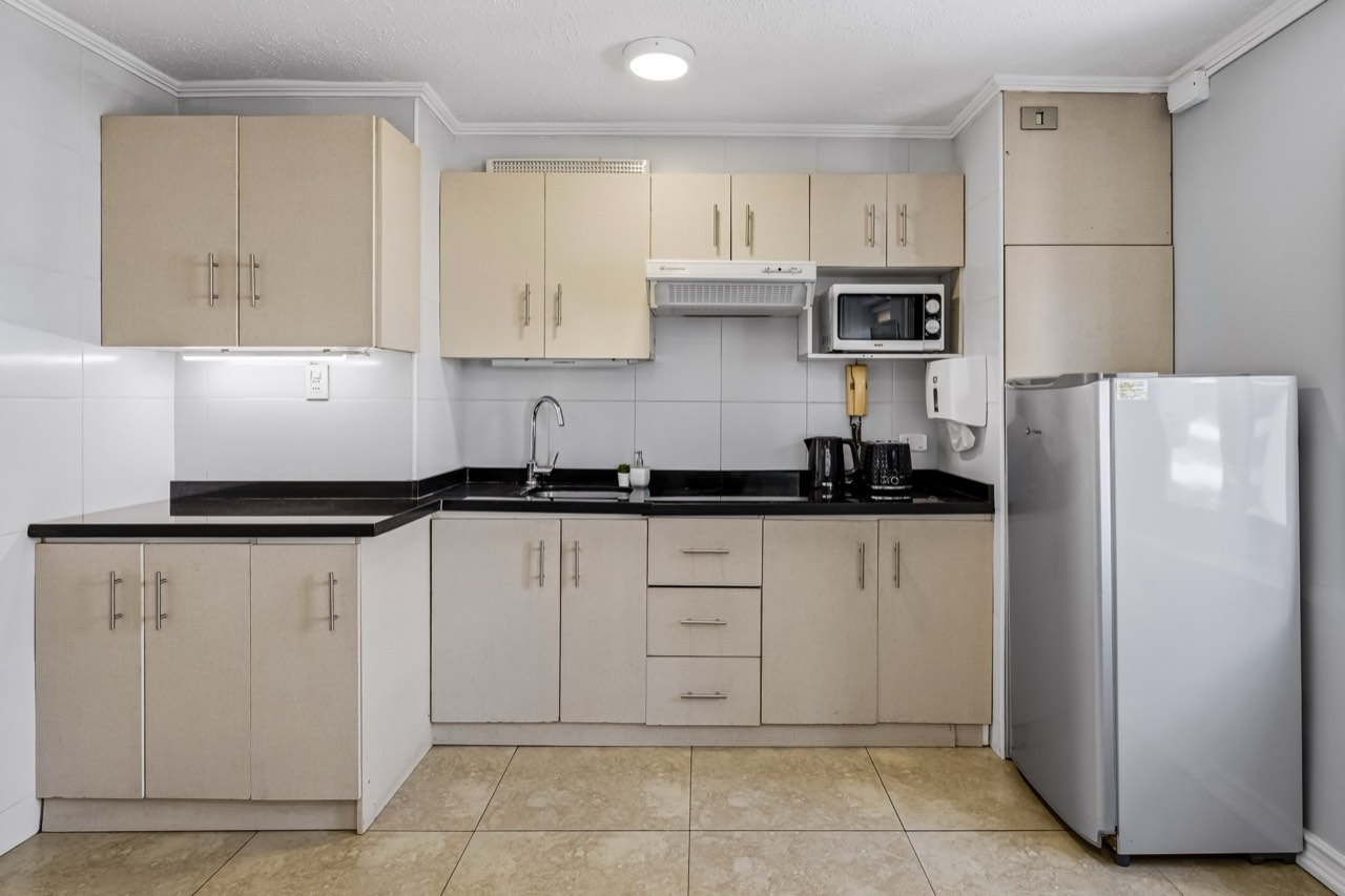 Cocina en L vista amplia - Suite 803 Suites Vitacura