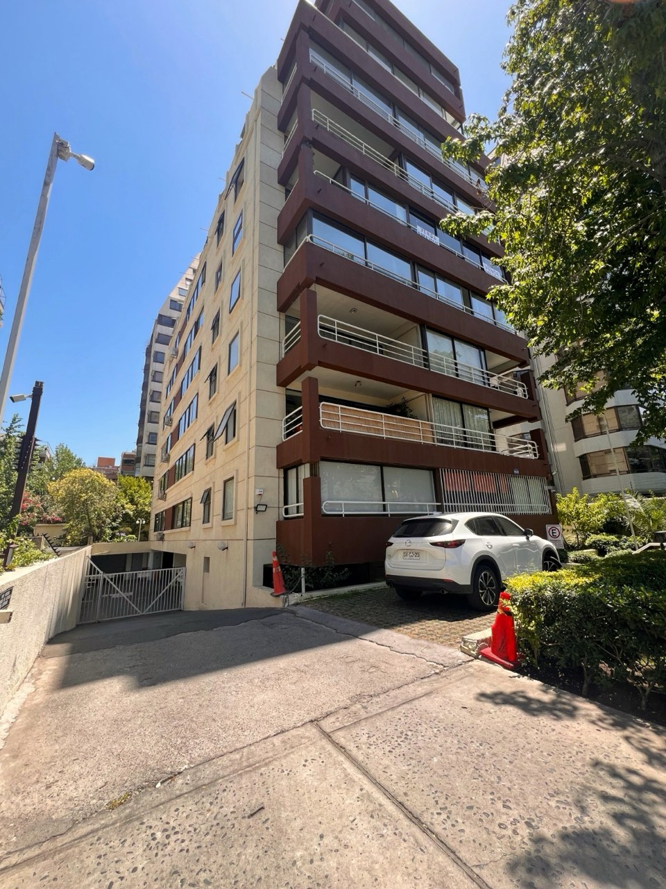Fachada exterior del edificio con acceso vehicular - Suites Vitacura